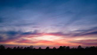 A serene landscape with purple skies at sunset, symbolizing spiritual awakening.