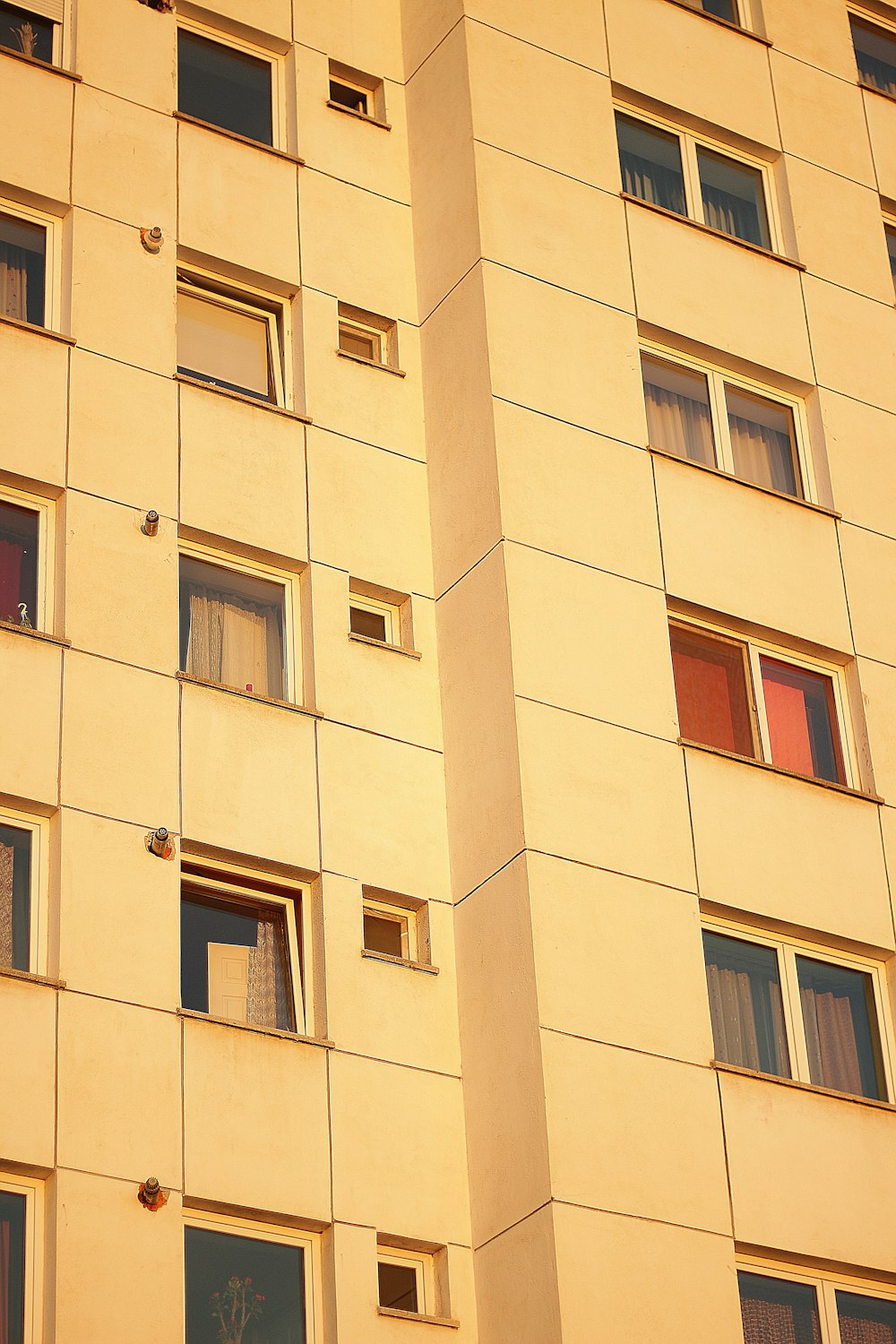 beige concrete building with glass windows