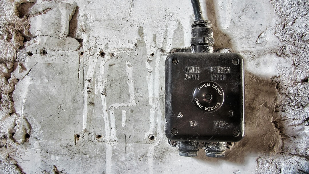 grey and black corded device on wall
