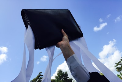 Close-up of a courier's hand placing a vital document into a secure briefcase at an airport runway.
