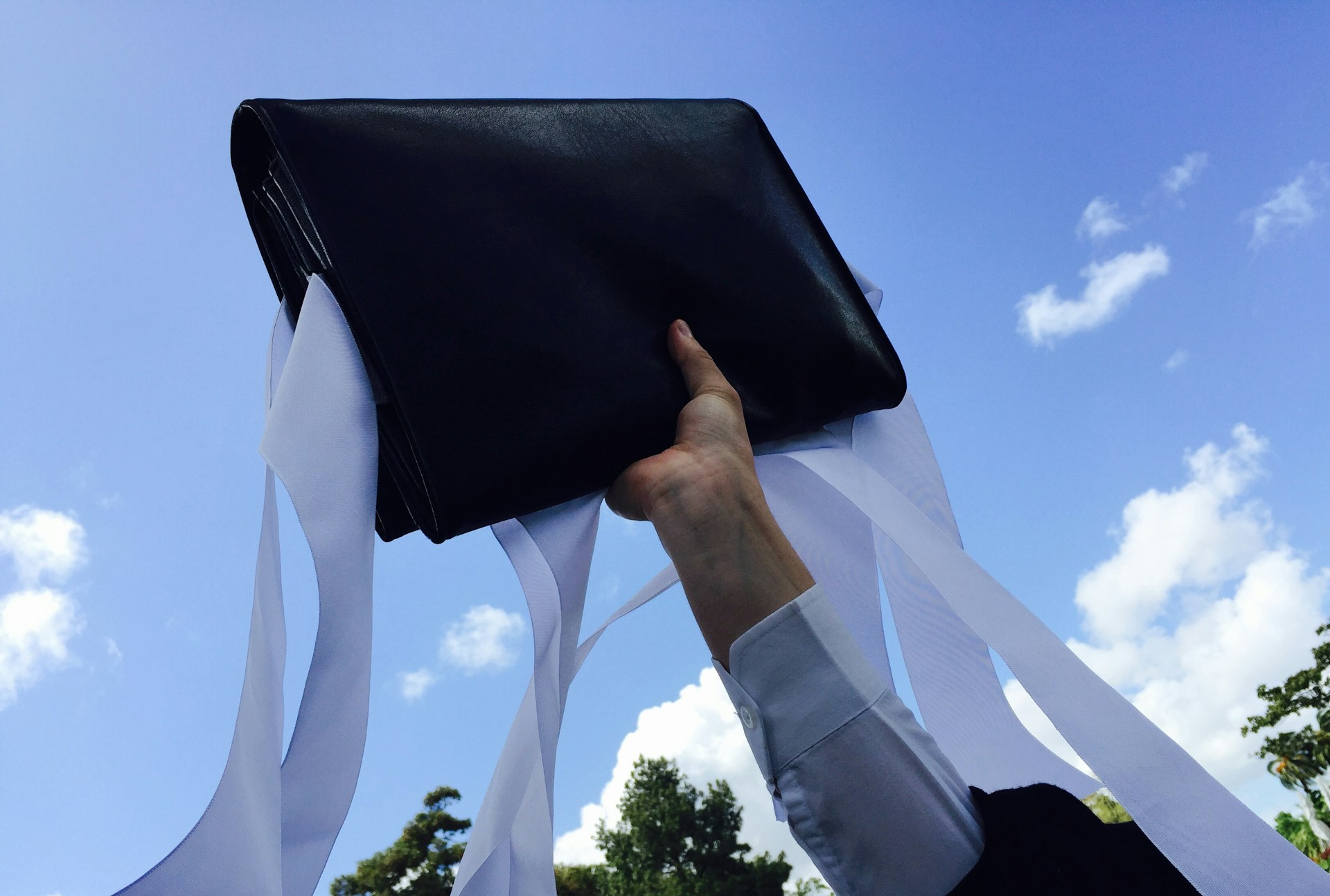 woman wearing yellow long-sleeved dress under white clouds and blue sky during daytime