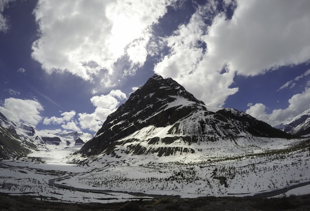 photo of rock mountain covered with snow