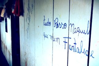 A cozy workspace with vintage clothing racks and a handwritten note saying 'We'd love to hear from you!'