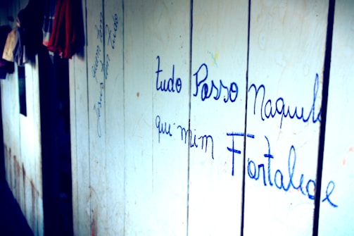 A cozy workspace with vintage clothing racks and a handwritten note saying 'We'd love to hear from you!'