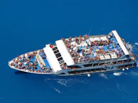Guests enjoying a lively boat tour with splashes of ocean spray and bright smiles.