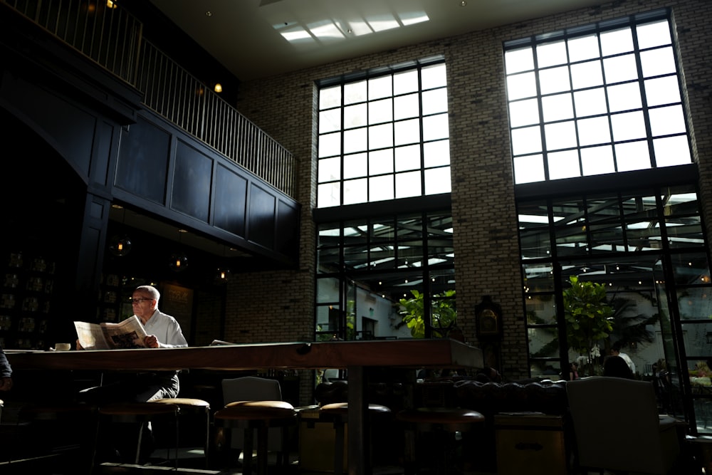 Man sitting and reading the newspaper.