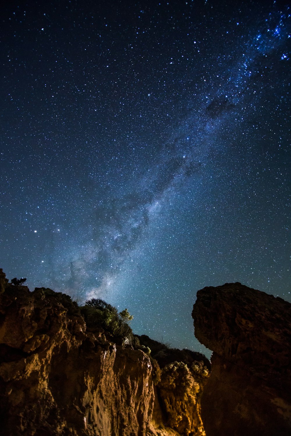 brown rocky mountain under starry night