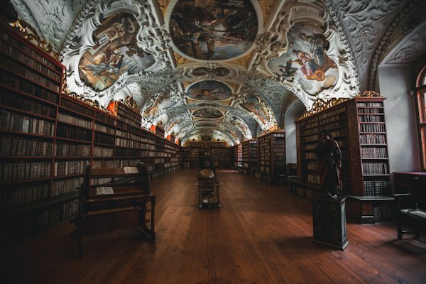 Photo of library with religious embossed ceiling — Prague, Czech Republic