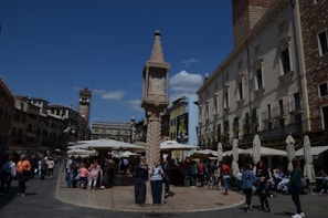 A vibrant street scene near a forgotten monument, with colorful market stalls and locals going about their day