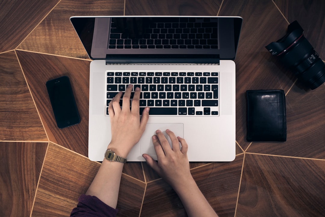 person using MacBook Pro, Hands on a laptop keyboard