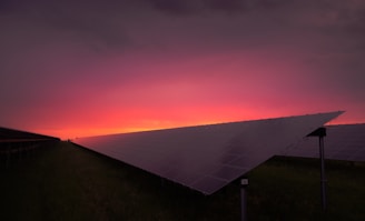 A sleek solar farm control room with glowing panels and modern equipment at dusk