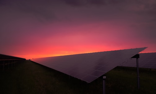 A sleek solar farm control room with glowing panels and modern equipment at dusk