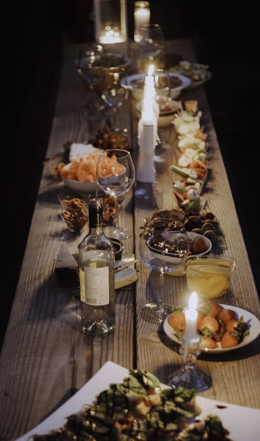 a long wooden table with plates of food on it