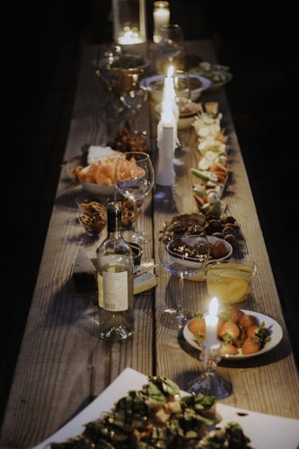 Small candles and a serving dish arranged on a dining table before guests arrive