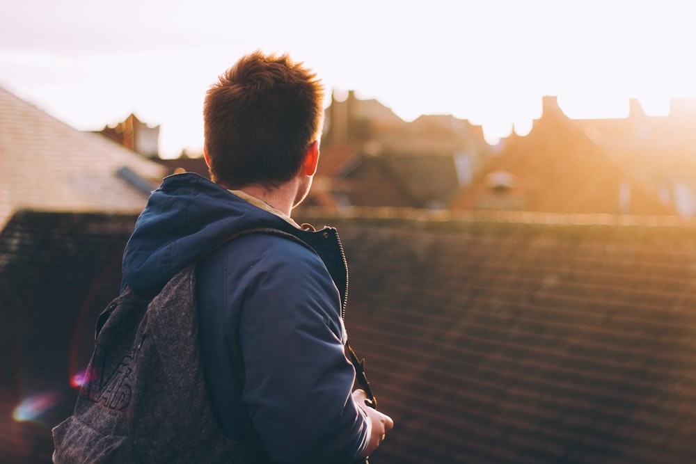 man facing on brown roof on rooftop