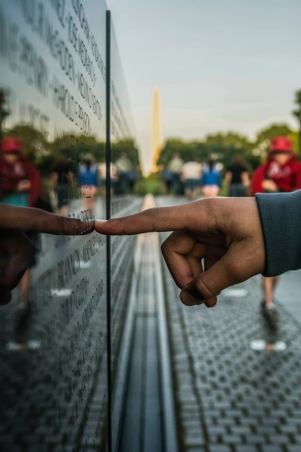 A person pointing at a monument on Memorial Day.