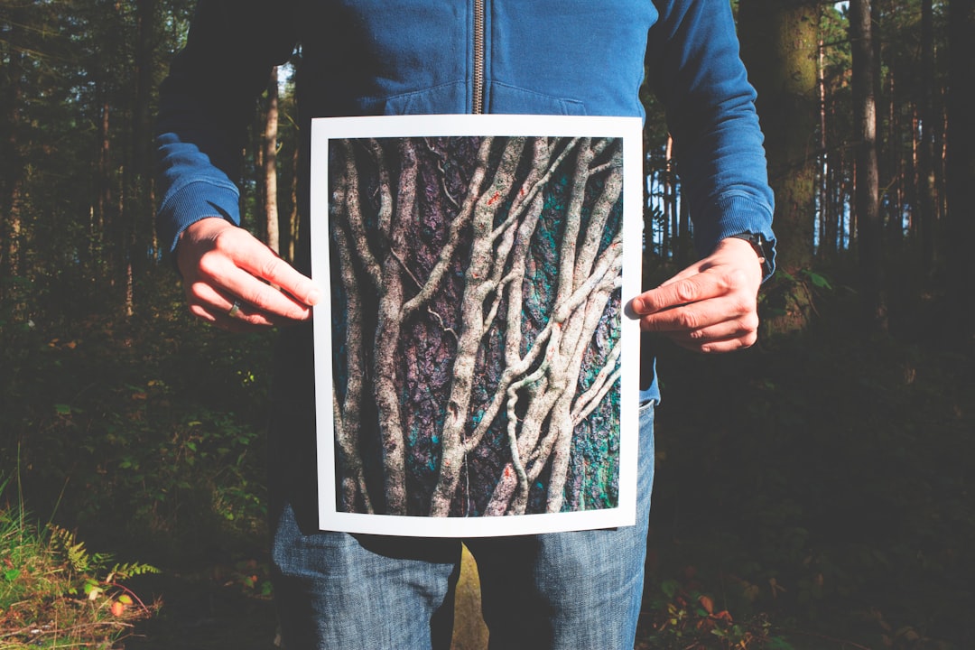 person holding photo of roots