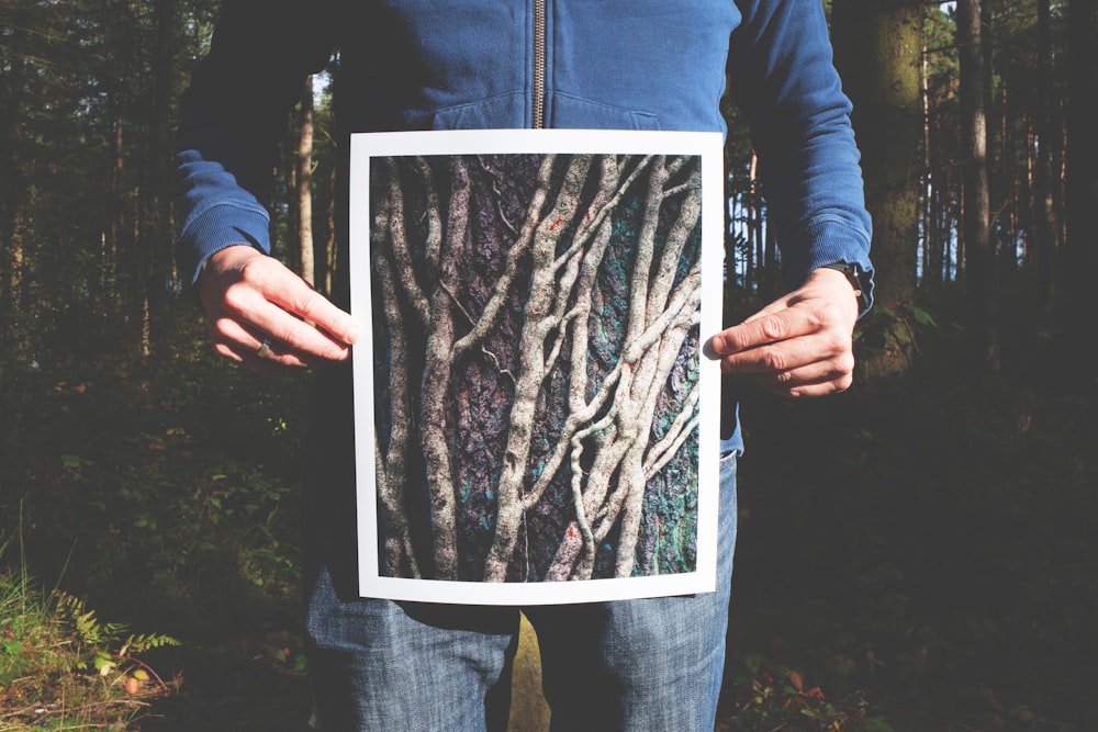 person holding photo of roots