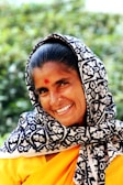 woman wearing white and black floral scarf while smiling