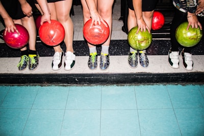 person holding bowling balls