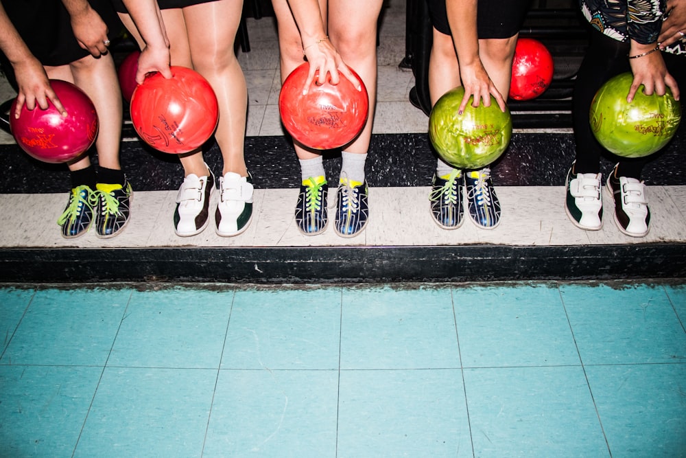 person holding bowling balls