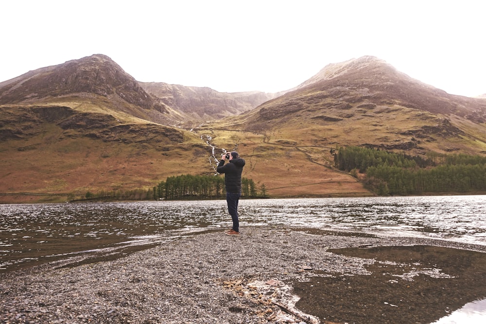 person taking photo of mountain