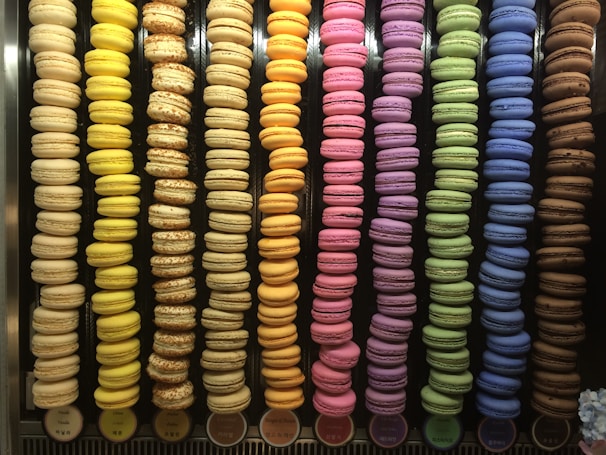 Rows of pastel-colored macarons stacked neatly, highlighting their smooth shells and creamy fillings.
