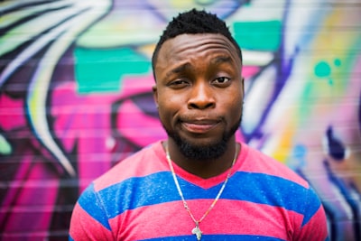 black haired man making face portrait zoom background