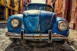blue vehicle parked near building at daytime