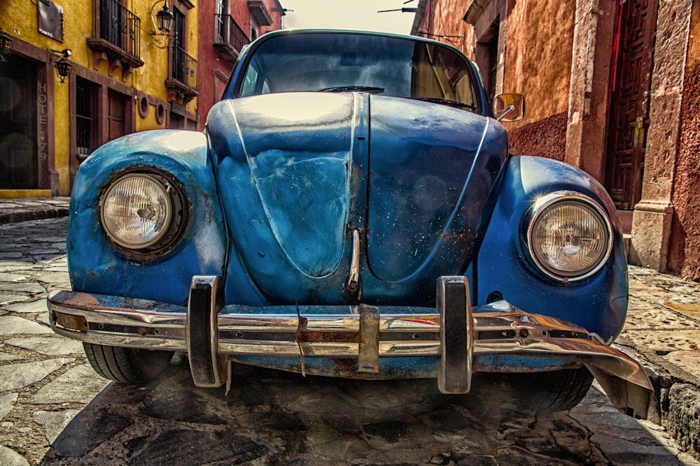 blue vehicle parked near building at daytime