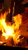 Participants engaged in a spiritual ceremony with sacred flames.
