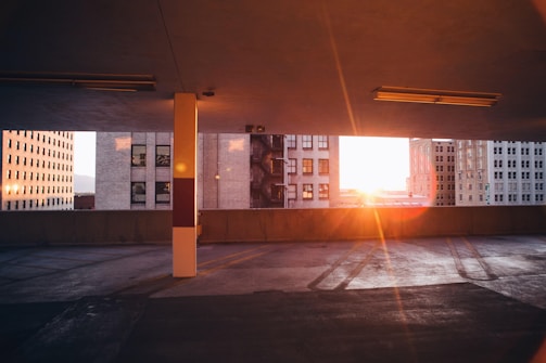 Evening view of a well-lit axial parking space with yellow and blue accents.