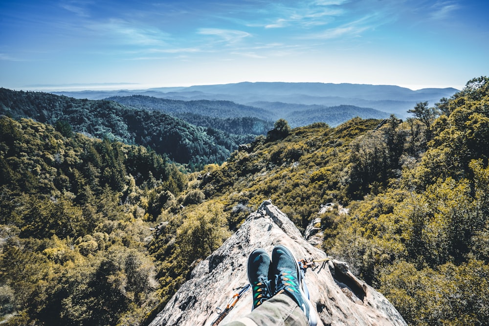 person sitting on cliff