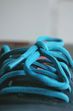 A close-up of colorful shoelaces artfully arranged on a wooden table.