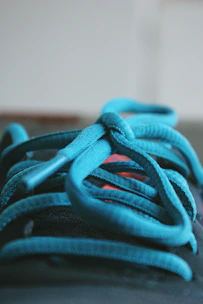 A close-up of colorful shoelaces artfully arranged on a wooden table.
