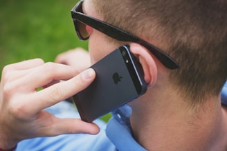 person holding black iPhone 5s
