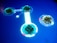 A digital interface featuring glowing blue circular icons with different symbols. The icons are connected through a bright line on a smooth blue surface, resembling a futuristic touch screen. Intricate designs and circuit-like patterns can be seen within the icons.