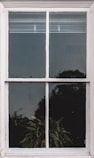 white wooden frame glass panel window with white window blinds