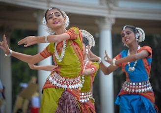 three woman performing traditional dance