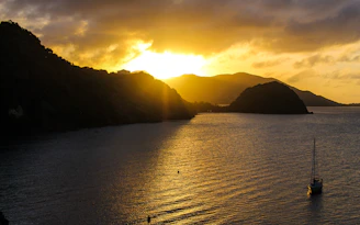 Sunset view over the serene Limanağzı bay with soft golden light reflecting on calm waters.