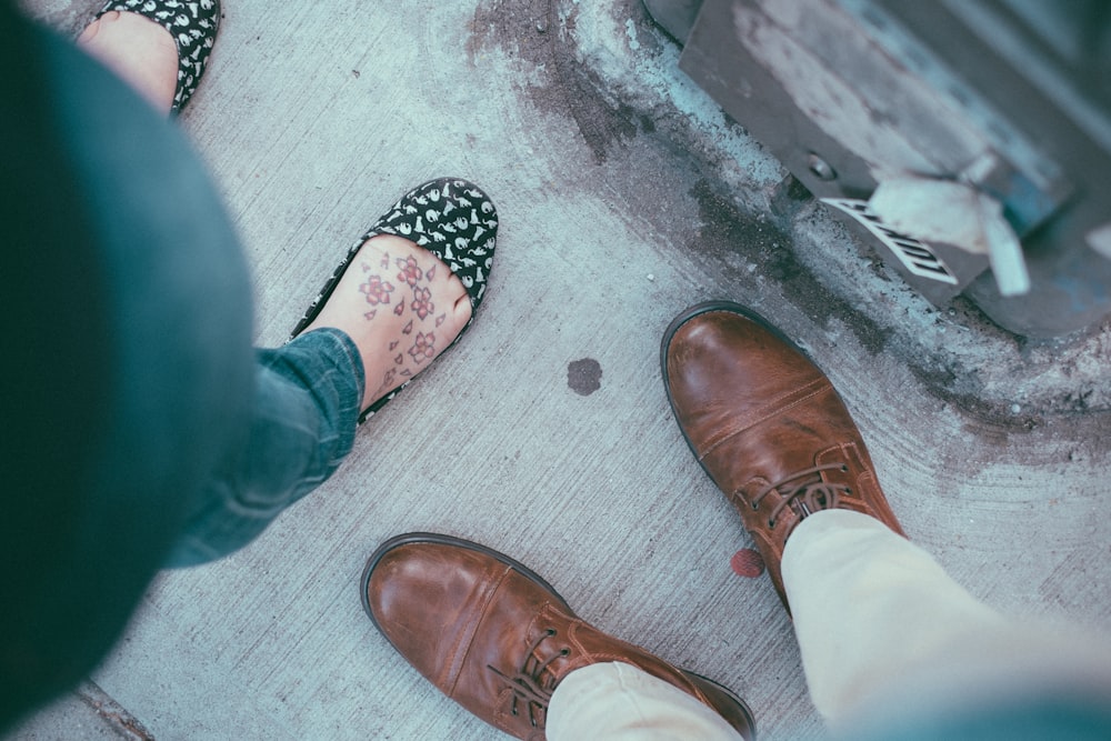 person wearing brown lace-up shoes