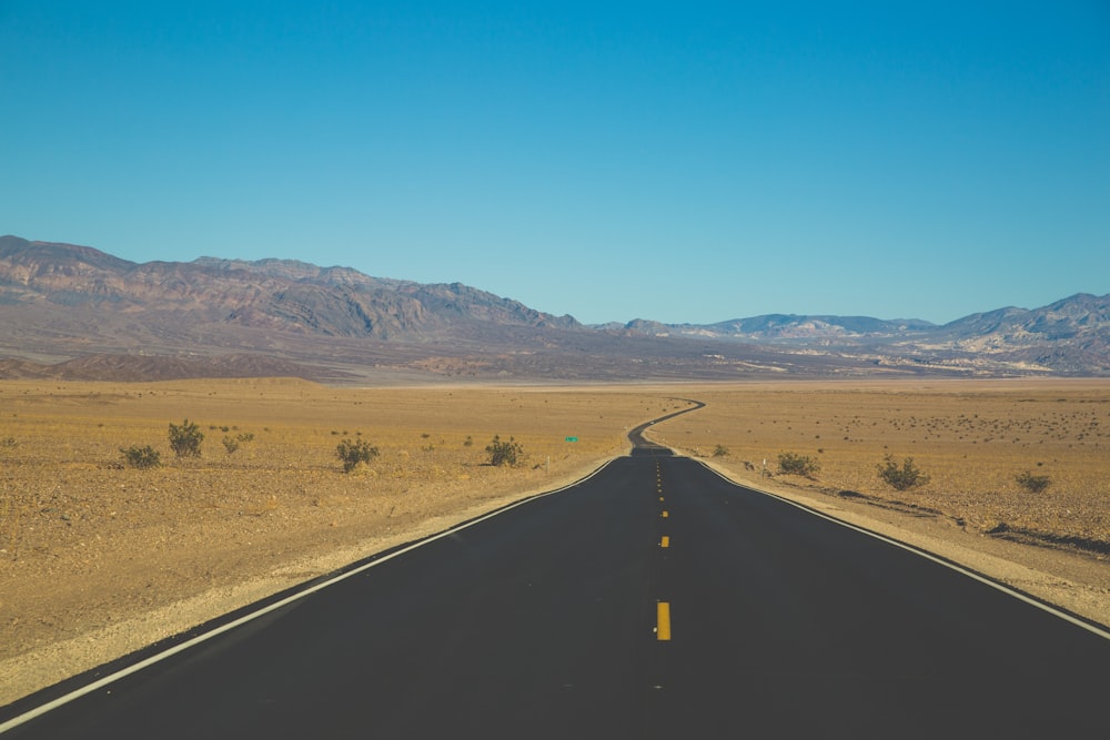 asphalt road towards mountain