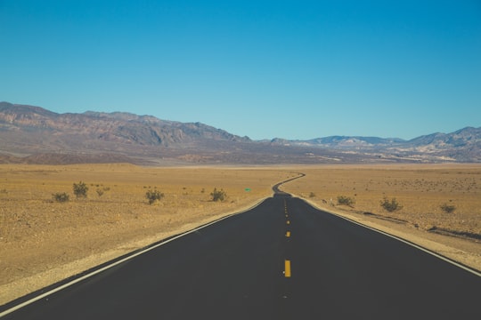 asphalt road towards mountain in Death Valley United States