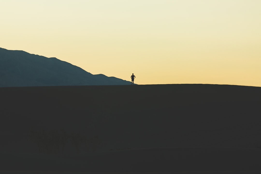 silhouette of person standing on mountain
