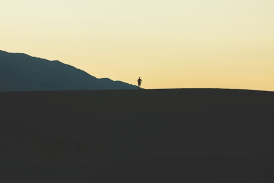 silhouette of person standing on mountain in Death Valley National Park United States