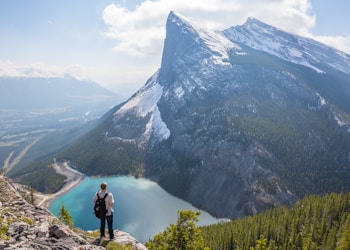 aerial photography of man standing on hill