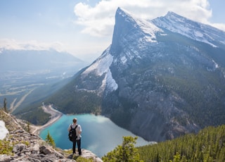 aerial photography of man standing on hill