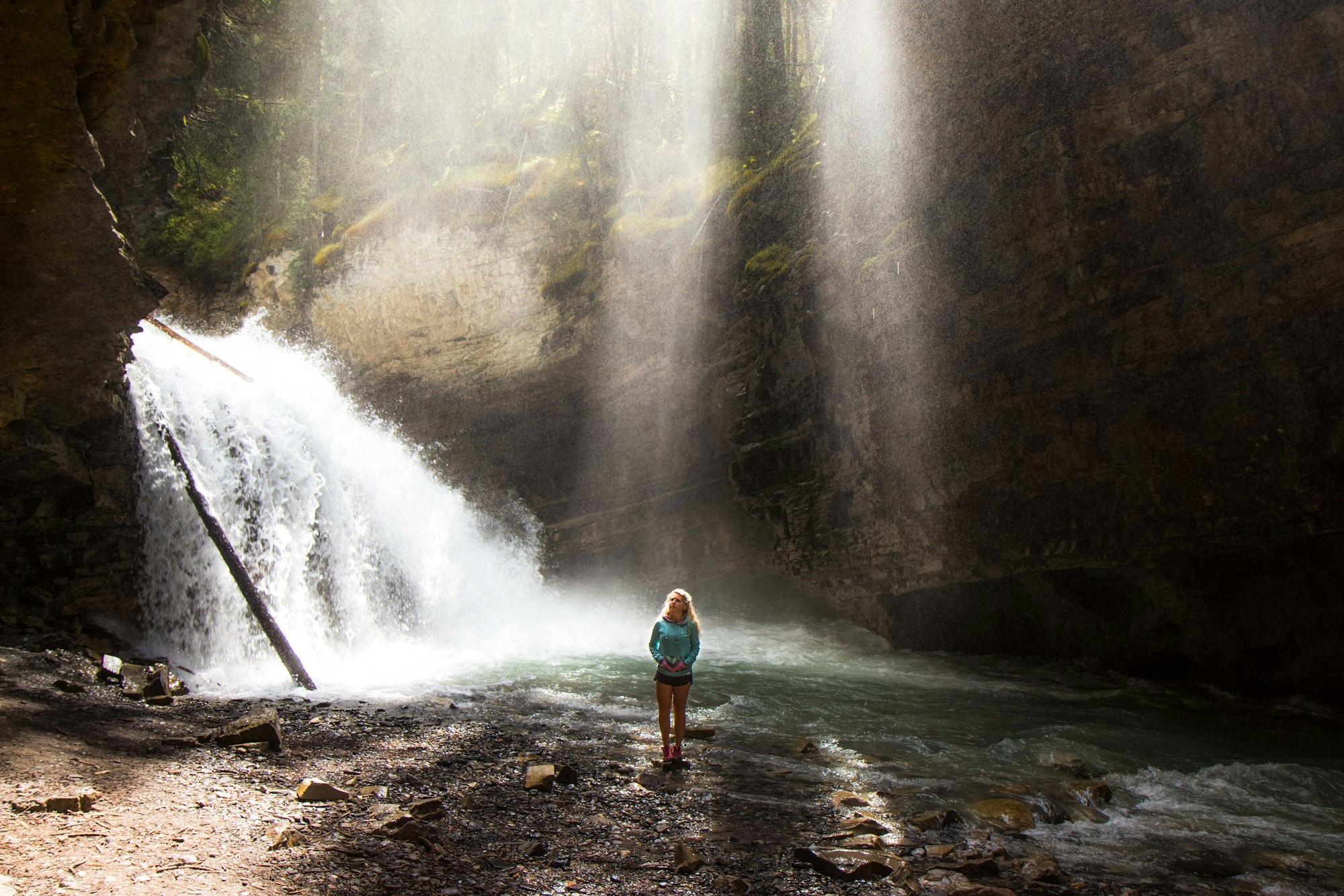 Woman near a frothy waterfall