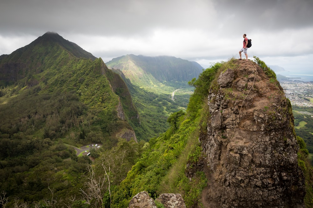 man on top of the mountain during daytime