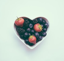 heart-shaped bowl with strawberries